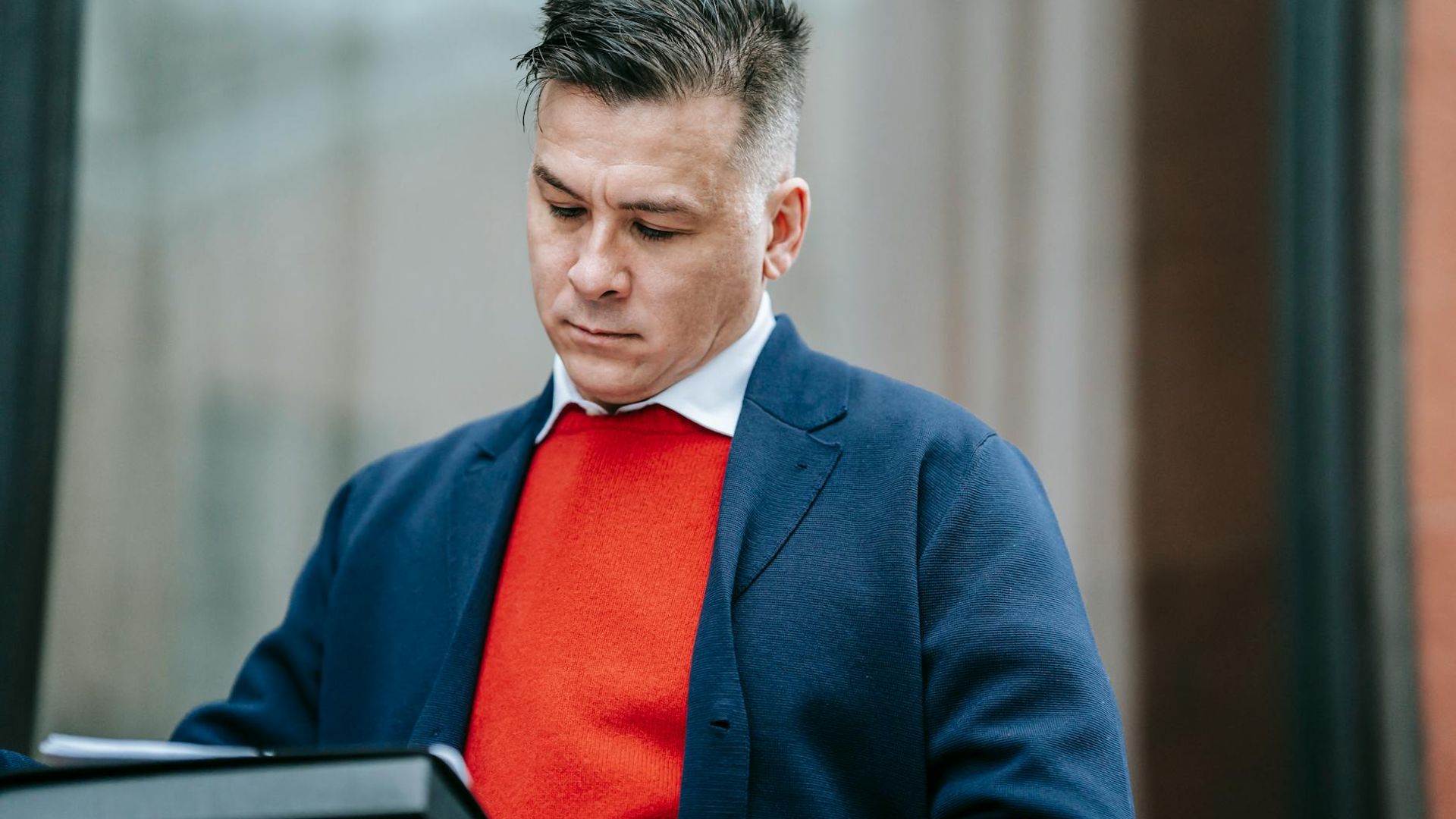 Person working in a focused environment with blue lighting.